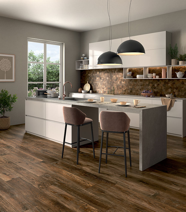 Cuisine blanche moderne avec îlot bar-dînette, sol en lames foncées de grès cérame effet bois et crédence en mosaïque céramique hexagonale assortie